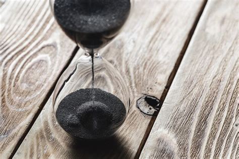 Premium Photo Modern Hourglass On Wooden Surface