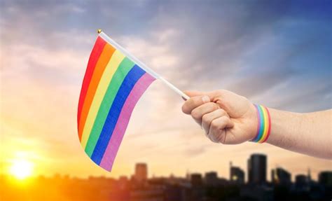 Premium Photo Hand With Gay Pride Rainbow Flag And Wristband