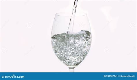 Water Being Poured Into Glass Against White Background Stock Image