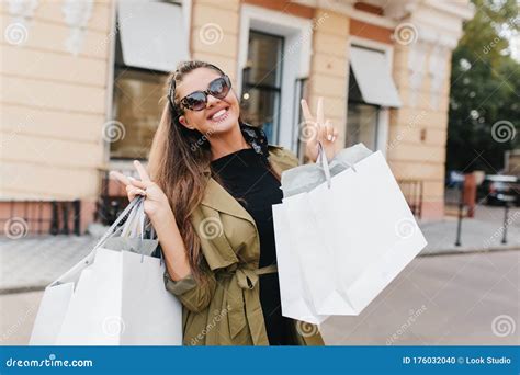 Excited Brunette Girl With Nude Make Up Bought Some New Clothes And Happy For It Outdoor Photo