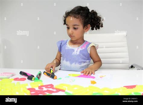 3 Year Old Latina Brunette Girl With Curly Hair Draws As Therapy For