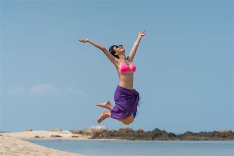 Premium Photo Portrait Of Thai Woman In A Bikini Jumping At The Beach