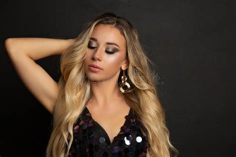 Elegant Blonde Model With Bright Makeup And Curly Hair Stock Photo