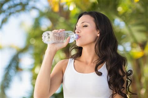 Premium Photo Pretty Brunette Drinking Bottle Of Water