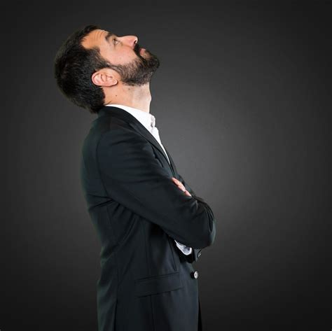 Premium Photo Handsome Businessman Looking Up On Black Background