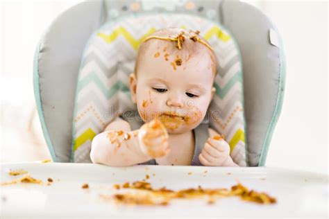 Little Baby Eating Her Dinner And Making A Mess Stock Photo Image Of