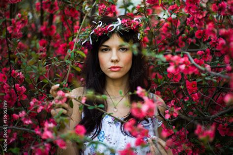Beautiful Brunette Posing In A Flower Garden Stock Photo Adobe Stock