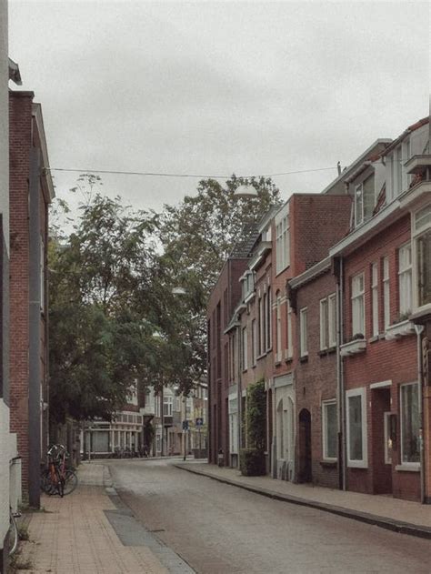 Street Between Brick Houses In Town · Free Stock Photo