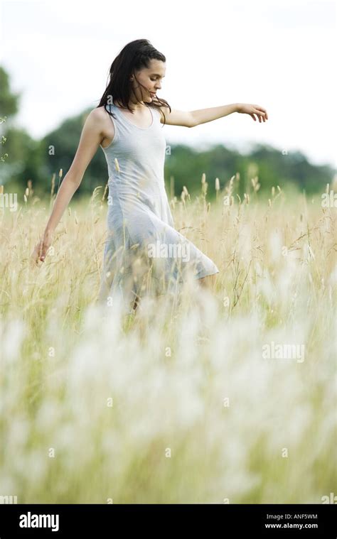 Teen Girl Walking Through Field Stock Photo Alamy