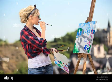 Beautiful Blonde Woman Artist Paints A Colorful Picture Stock Photo Alamy