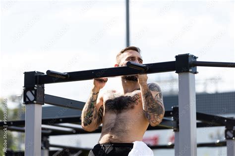 Muscular Bodybuilder Handsome Man With Naked Torso Trains Triceps In A Crossover Cable Exercise
