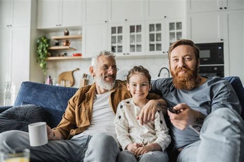Positive Gay Parents Hugging Daughter While Stock Image Image Of Film Click