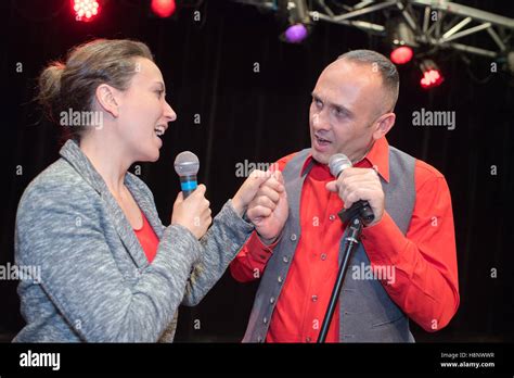 portrait of beautiful couple of professional singers on stage Stock