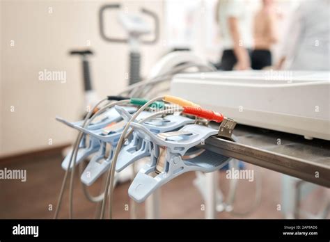 Clothespins Of The Ecg Machine In The Foreground Athlete Does A