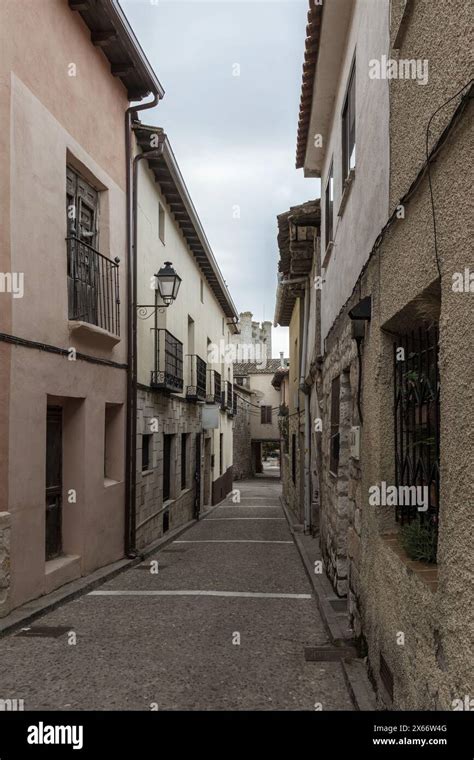 Narrow Stone Paved Street Flanked By Old Textured Buildings Under A