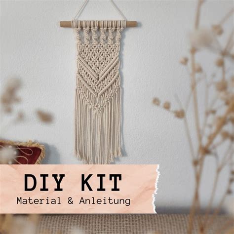 The Diy Kit Is Hanging On A Wall Next To Some Dried Flowers And A Chair