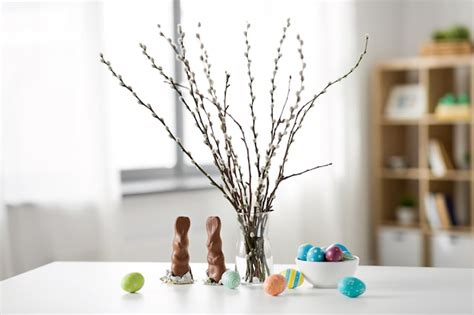 Premium Photo Pussy Willow Easter Eggs And Chocolate Bunnies