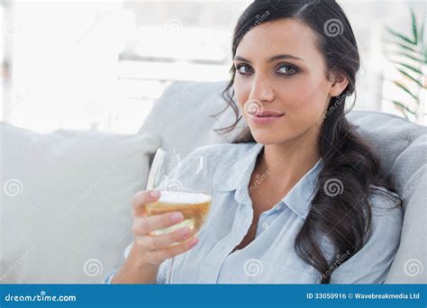 Pretty Brunette Drinking White Wine Sitting On Sofa Stock Photo Image Of Calm Looking