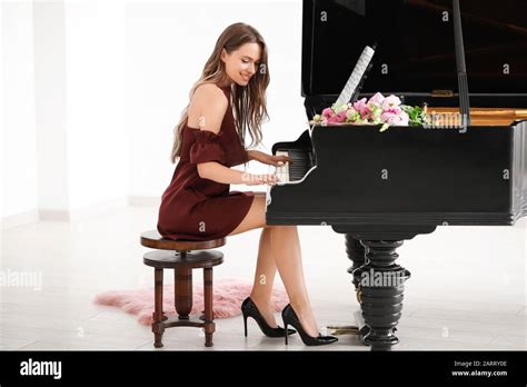 Young woman playing grand piano at the concert Stock Photo - Alamy