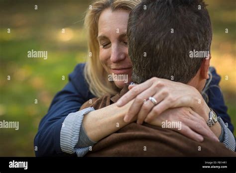 Close Up Of Romantic Mature Couple Hugging In Garden Stock Photo Alamy