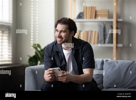 Happy Cheerful Cellphone User Guy Holding Mobile Phone Stock Photo Alamy