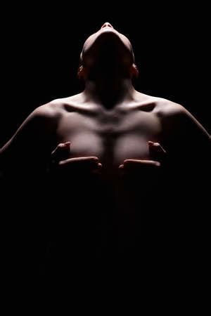 Nude Woman silhouette under light in the dark Beautiful Sexy Naked Body Girlの素材 FY