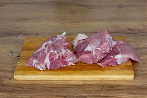 Premium Photo Raw Meat Displayed On A Wooden Board Showcases The