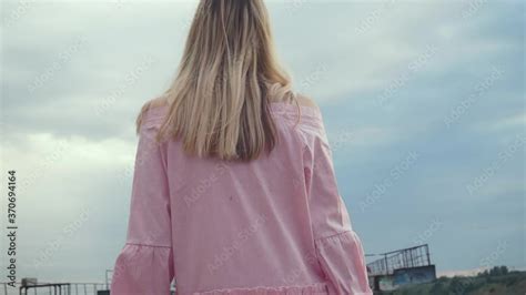 Camera Shoots From Behind Girl S Back Blonde With Long Hair Appears Large Building Object