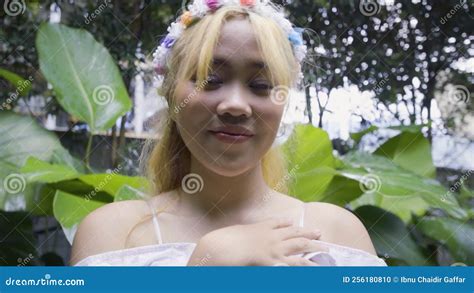 A Blonde Princess With A Pink Dress Playing In The Forest Castle With Green Leaves And Flowers