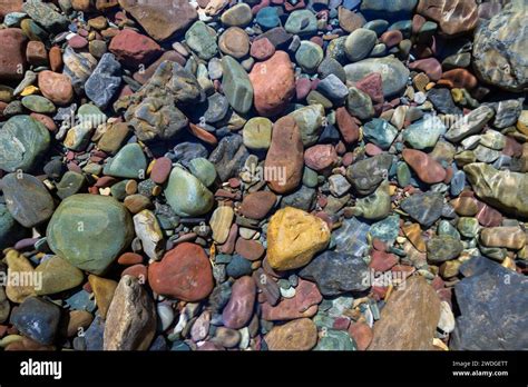 Naturally Colorful River Rocks Under Water In Glacier National Park