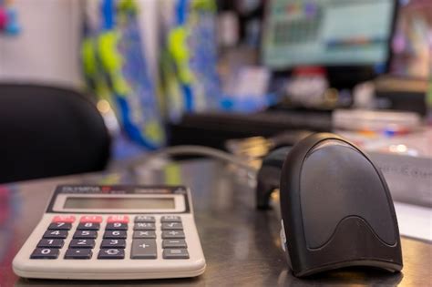 Premium Photo | Qr code scanner on table with calculator with casheer ...