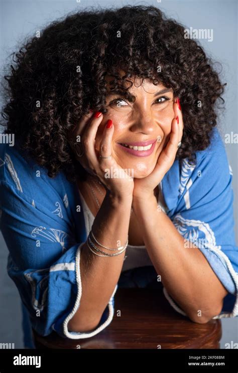 Portrait Of Smiling Beautiful Curly Hair Model Against Light Background Mature Woman Self