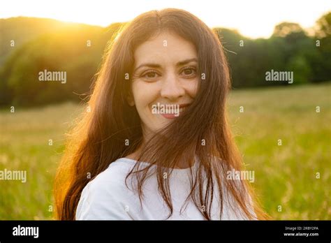 Portrait Of A Year Old Brunette Woman Looking At The Camera Smiling In Nature Stock Photo Alamy