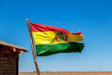 Bolivian Flag Waving In The Wind Against Blue Sky Background Stock