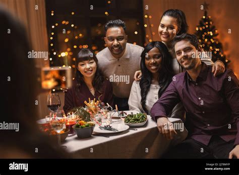 Happy Friends Photographing At Christmas Dinner Stock Photo Alamy