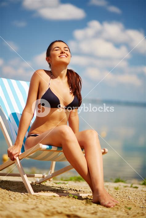 Happy Girl In Bikini Sunbathing On The Beach Royalty Free Stock Image Storyblocks
