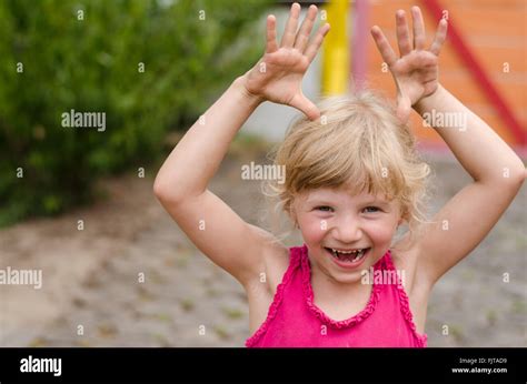 Portrait de l adorable petite fille blonde en souriant et faisant des gestes drôles Photo Stock