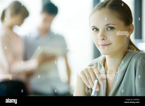 Young Woman Holding Pen Smiling At Camera Stock Photo Alamy