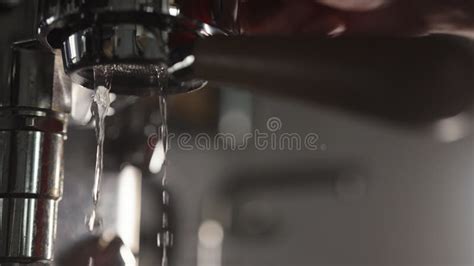 Low Angle Flush Coffee Machine Before Extraction With Naked Portafilter Into White Cup Stock