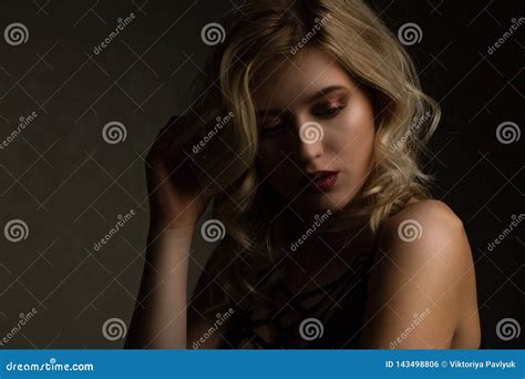 Sensual Blonde Model With Perfect Makeup And Naked Shoulders Posing With Contrast Light Empty