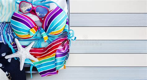 Colorful Bikini And Clothes In Luggage With Tropical Leaves Stock Image
