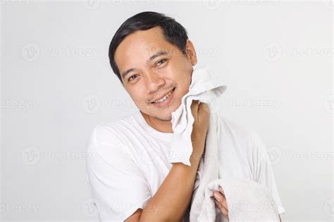 Portrait Of Attractive Asian Man Wiping His Face With Towel After