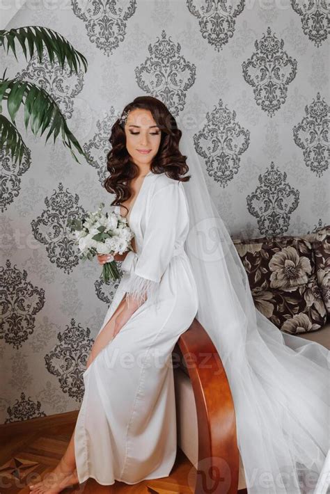 A Beautiful Brunette Bride With A Tiara In Her Hair Is Getting Ready For The Wedding In A