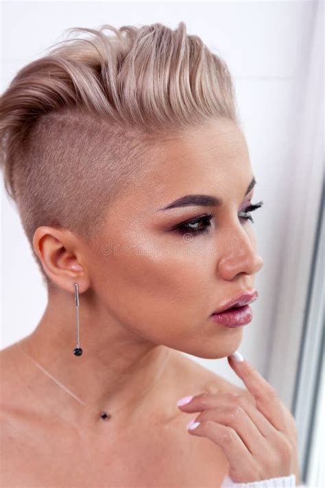 Closeup Blonde Model With Bright Make Up Bare Shoulders And Short Hair With Shaved Temples In