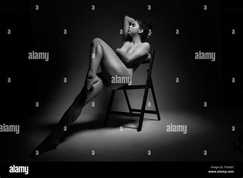 Naked Woman Sitting On A Wooden Chair In Black And White Stock Photo Alamy