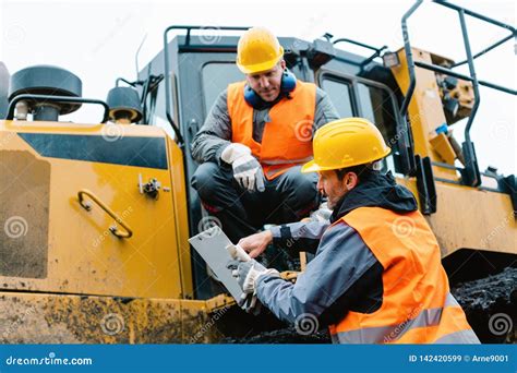 worker  heavy excavation machinery  mining operation stock image