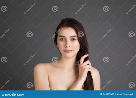 Confident Good Looking Beautiful Woman With Brunette Hair With Healthy Pure Skin Stock Photo