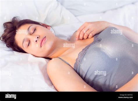 Beautiful Brunette Lying On Bed Sleeping Stock Photo Alamy