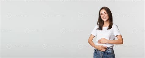 Satisfied Smiling Brunette Girl Rubbing Belly After Eating Delicious Food 48908948 Stock Photo