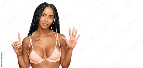 Beautiful Hispanic Woman Wearing Bikini Showing And Pointing Up With Fingers Number Six While